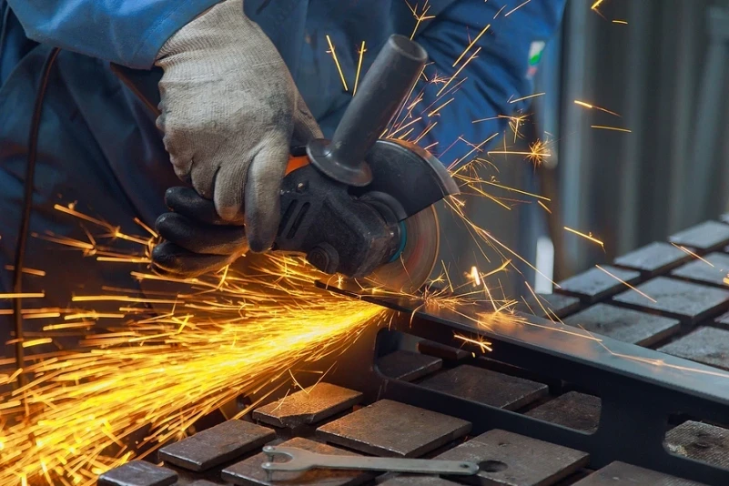 Construction worker using angle grinder